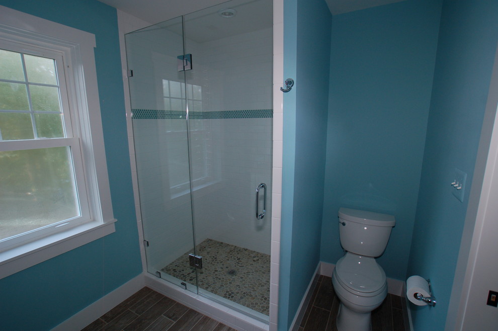 Inspiration for a medium sized beach style ensuite bathroom in DC Metro with a submerged sink, flat-panel cabinets, white cabinets, granite worktops, blue walls and porcelain flooring.