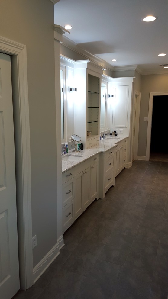 Bathroom - large contemporary master white tile and subway tile porcelain tile and brown floor bathroom idea in New Orleans with recessed-panel cabinets, white cabinets, an undermount tub, gray walls, an undermount sink and marble countertops