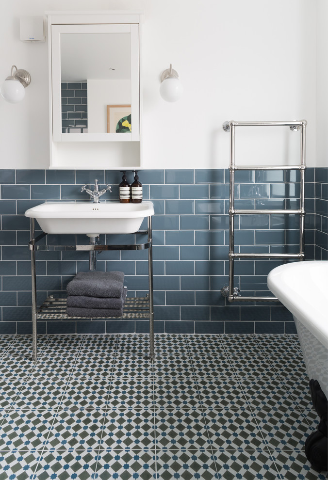 Photo of a classic half tiled bathroom in London with multi-coloured floors and feature lighting.
