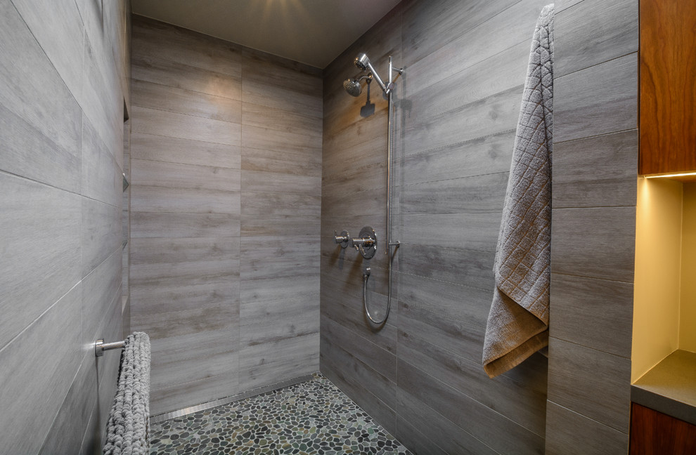 Inspiration for a mid-sized modern master gray tile and porcelain tile pebble tile floor bathroom remodel in Los Angeles with flat-panel cabinets, medium tone wood cabinets, gray walls and quartz countertops