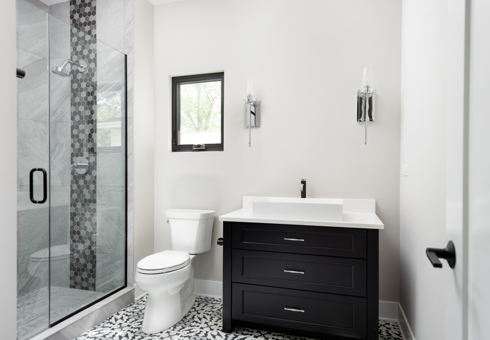 Photo of a medium sized rural family bathroom in Chicago with shaker cabinets, black cabinets, an alcove shower, a two-piece toilet, grey tiles, grey walls, porcelain flooring, an integrated sink, grey floors, a hinged door, white worktops, a single sink and a built in vanity unit.