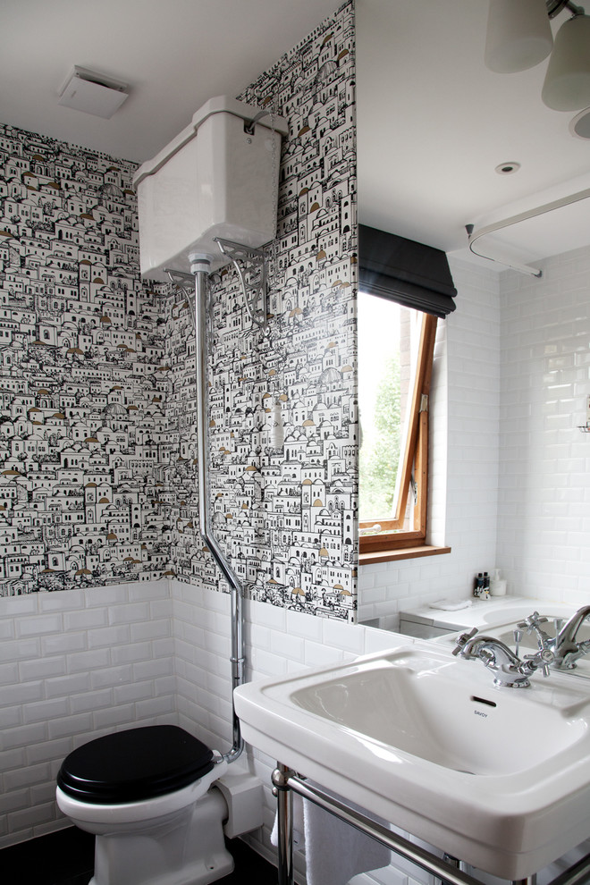 Photo of a modern half tiled bathroom in London.