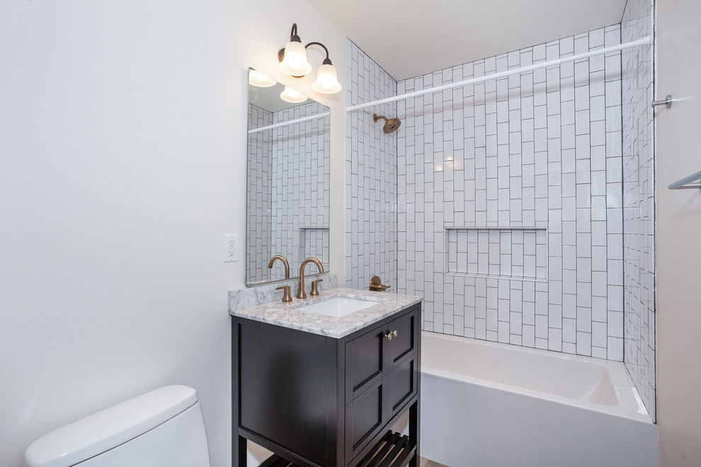 Example of a mid-sized trendy kids' white tile and subway tile porcelain tile bathroom design in Los Angeles with recessed-panel cabinets, dark wood cabinets, a one-piece toilet, white walls, an undermount sink and marble countertops
