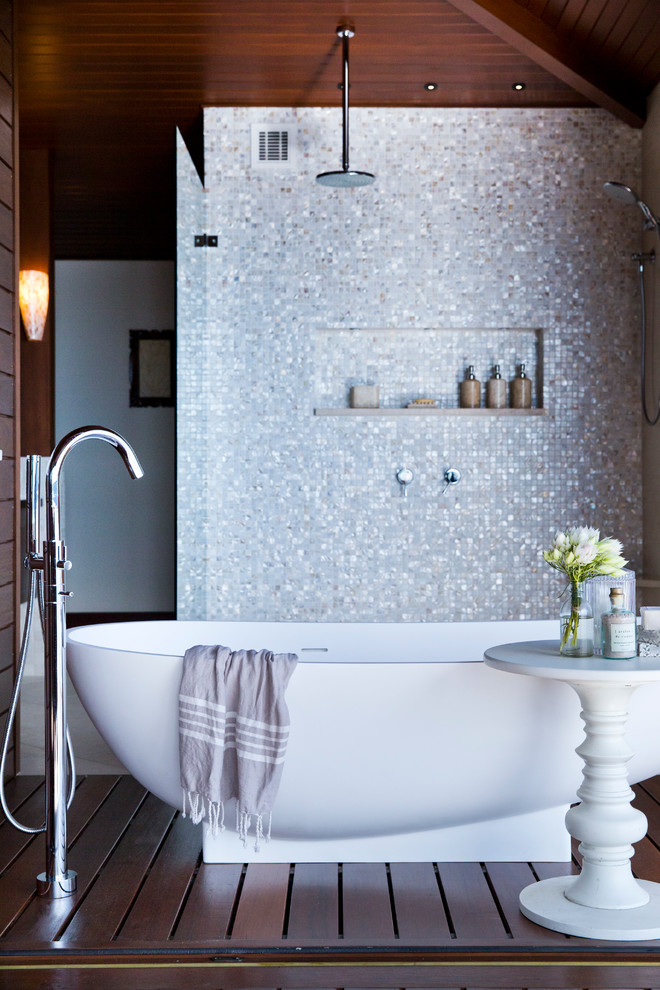 Immagine di una stanza da bagno tradizionale con vasca freestanding, vasca/doccia e piastrelle a mosaico