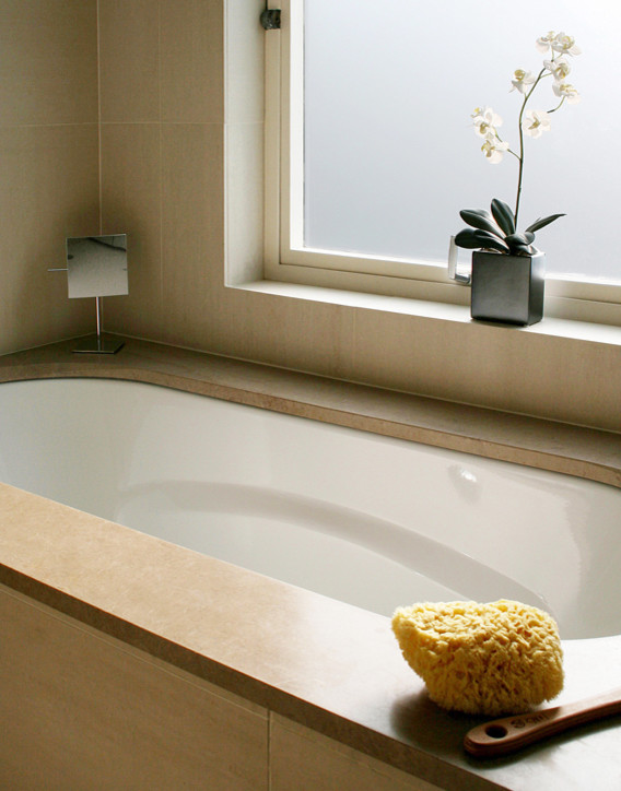 Foto di una stanza da bagno minimal di medie dimensioni con vasca sottopiano e pareti beige