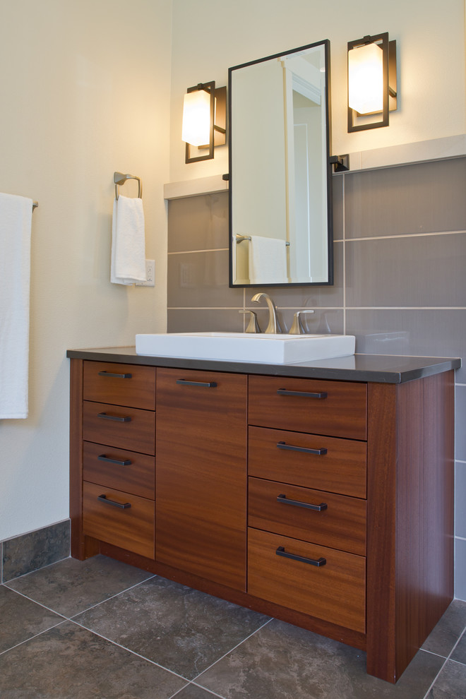 Large contemporary ensuite bathroom in Portland with a vessel sink, flat-panel cabinets, medium wood cabinets, engineered stone worktops, a freestanding bath, a walk-in shower, multi-coloured tiles, porcelain tiles, beige walls and porcelain flooring.