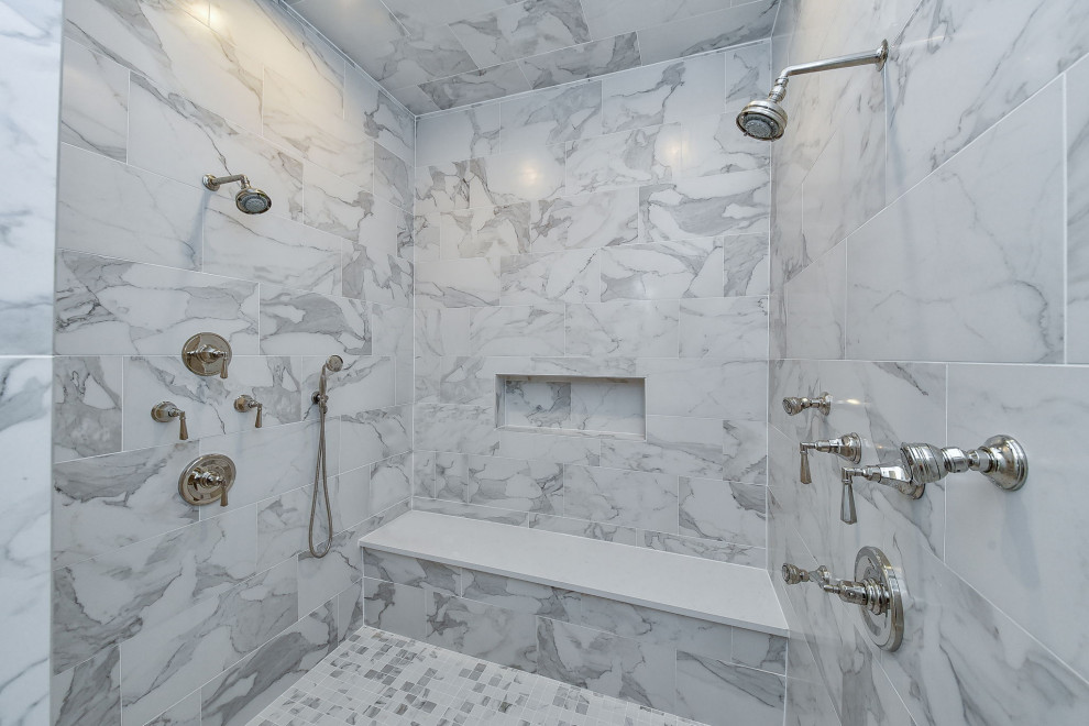 Inspiration for a large traditional ensuite bathroom in Chicago with flat-panel cabinets, white cabinets, a double shower, a one-piece toilet, white tiles, porcelain tiles, white walls, marble flooring, a submerged sink, engineered stone worktops, white floors, a hinged door, white worktops, an enclosed toilet, double sinks, a built in vanity unit, a vaulted ceiling and wainscoting.