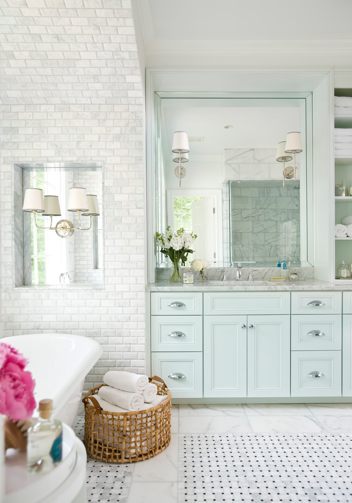 Inspiration for a large traditional ensuite bathroom in Atlanta with recessed-panel cabinets, blue cabinets, a freestanding bath, grey tiles, white tiles, metro tiles, white walls, marble flooring, a submerged sink and marble worktops.
