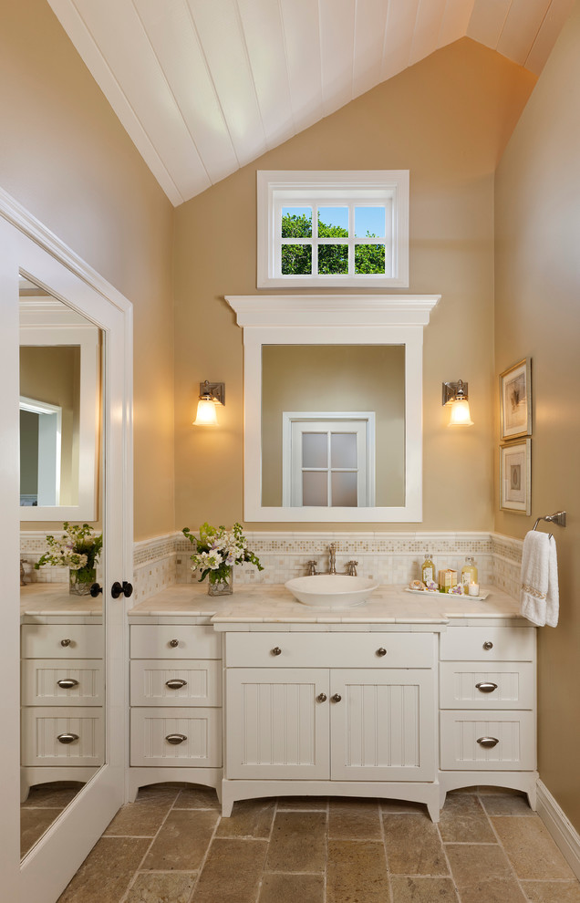 Elegant bathroom photo in Santa Barbara with marble countertops, a vessel sink and white countertops