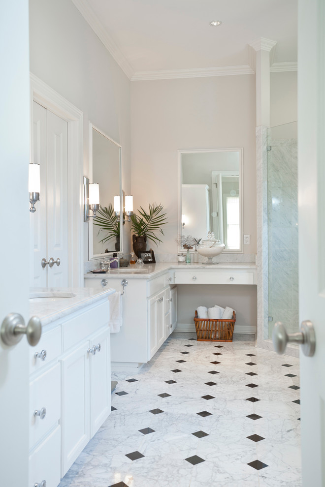 Bathroom - traditional master white tile and stone tile marble floor bathroom idea in Austin with an undermount sink, raised-panel cabinets, white cabinets, marble countertops, a two-piece toilet and gray walls