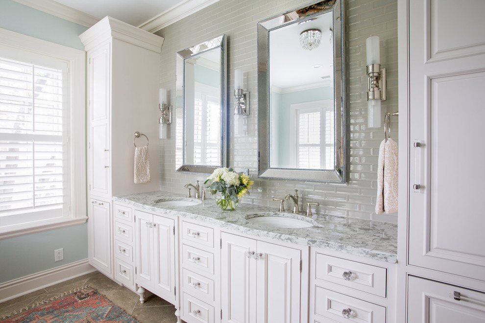 Mid-sized elegant master beige tile and subway tile limestone floor and beige floor bathroom photo in St Louis with beaded inset cabinets, white cabinets, a two-piece toilet, blue walls, an undermount sink, marble countertops and gray countertops