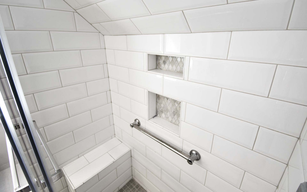 This is an example of a small traditional shower room bathroom in Portland with beaded cabinets, grey cabinets, an alcove shower, a two-piece toilet, white tiles, metro tiles, grey walls, ceramic flooring, a submerged sink, engineered stone worktops, grey floors, a sliding door, white worktops, a shower bench, double sinks and a built in vanity unit.