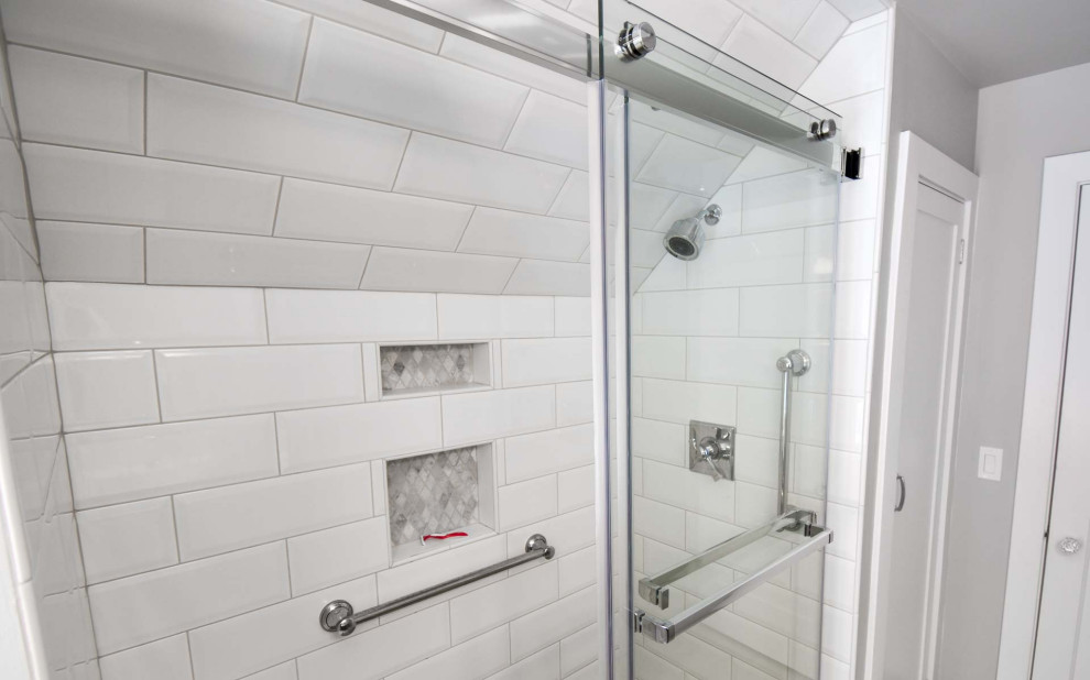 Photo of a small traditional shower room bathroom in Portland with beaded cabinets, grey cabinets, an alcove shower, a two-piece toilet, white tiles, metro tiles, grey walls, ceramic flooring, a submerged sink, engineered stone worktops, grey floors, a sliding door, white worktops, a shower bench, double sinks and a built in vanity unit.