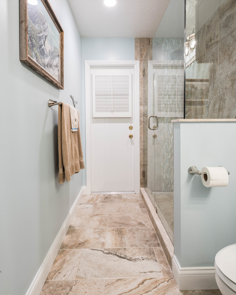 Inspiration for a large coastal 3/4 beige tile and porcelain tile porcelain tile and beige floor corner shower remodel in Other with beaded inset cabinets, white cabinets, blue walls, an undermount sink, recycled glass countertops and a hinged shower door