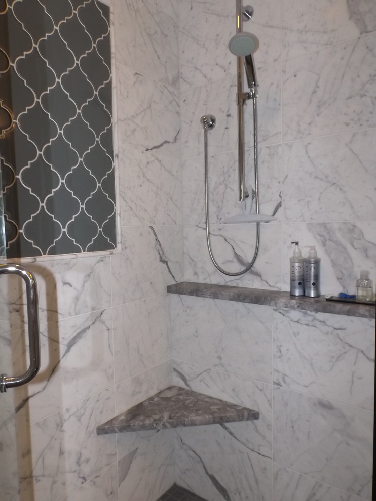 Photo of a large traditional ensuite bathroom in Boston with a submerged sink, raised-panel cabinets, white cabinets, granite worktops, a freestanding bath, an alcove shower, white tiles, porcelain tiles, grey walls and porcelain flooring.