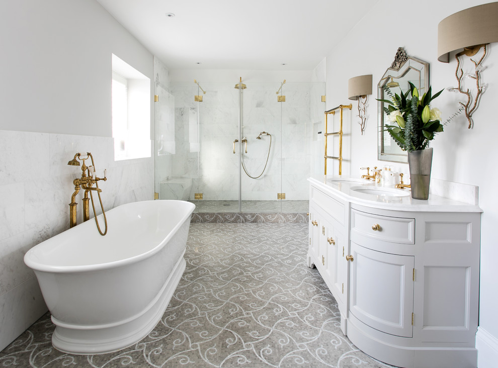 Large victorian ensuite bathroom in Surrey with grey cabinets, a freestanding bath, white tiles, stone tiles, grey walls, mosaic tile flooring, marble worktops, recessed-panel cabinets, an alcove shower, a submerged sink and a hinged door.