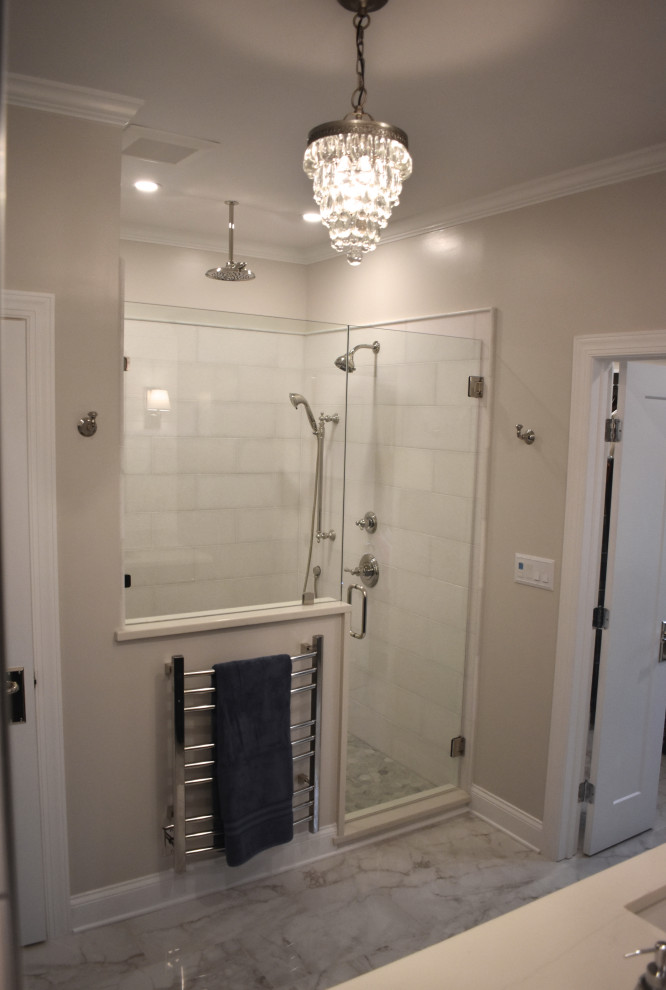 Large transitional master white tile and marble tile porcelain tile and gray floor alcove shower photo in Charlotte with recessed-panel cabinets, blue cabinets, a two-piece toilet, gray walls, an undermount sink, quartz countertops, a hinged shower door and white countertops