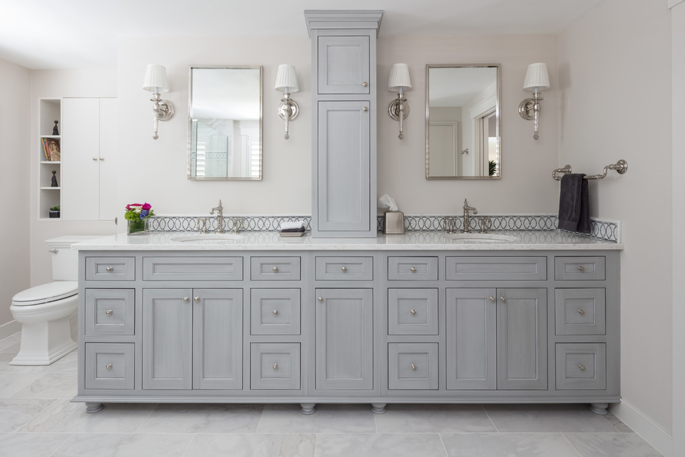 This is an example of a large traditional ensuite bathroom in Boston with grey cabinets, grey tiles, grey walls, a submerged sink, a two-piece toilet, mosaic tiles, marble flooring, engineered stone worktops, grey floors and recessed-panel cabinets.