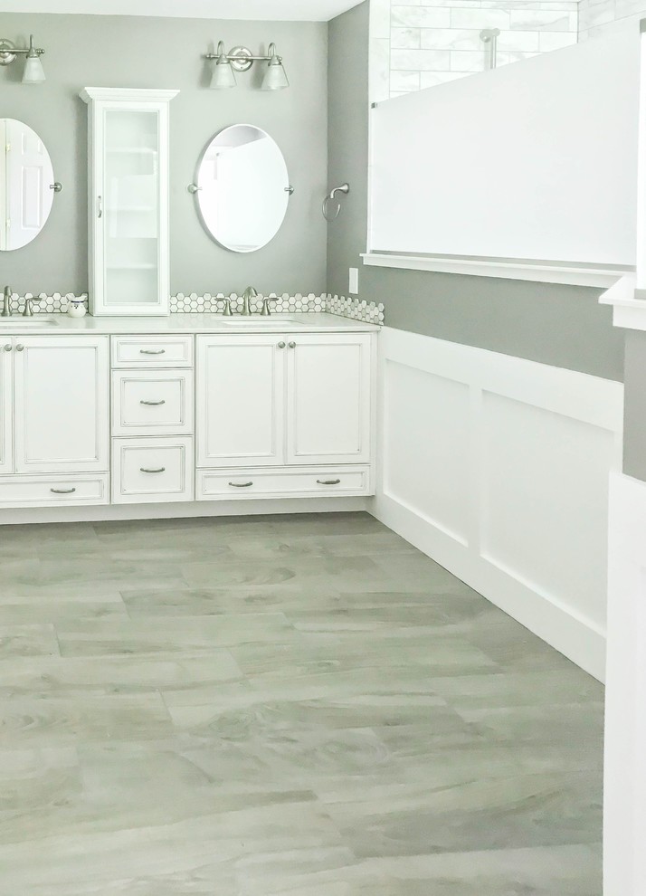 Example of a mid-sized transitional master gray tile and porcelain tile medium tone wood floor and gray floor bathroom design in Baltimore with beaded inset cabinets, white cabinets, gray walls, an undermount sink, quartz countertops and gray countertops