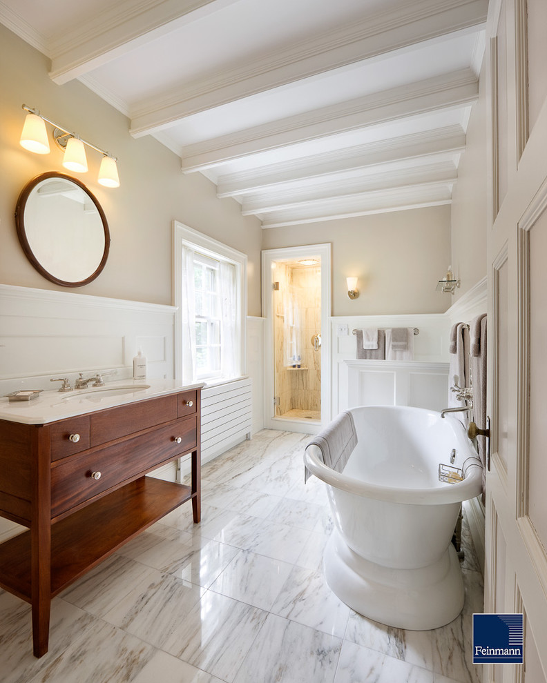 Elegant white tile and stone tile bathroom photo in Boston with an undermount sink, medium tone wood cabinets, marble countertops and flat-panel cabinets