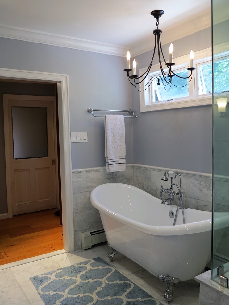 Example of a large cottage master multicolored tile and marble tile marble floor and multicolored floor bathroom design in New York with furniture-like cabinets, gray cabinets, a one-piece toilet, gray walls, an undermount sink, marble countertops, a hinged shower door and white countertops