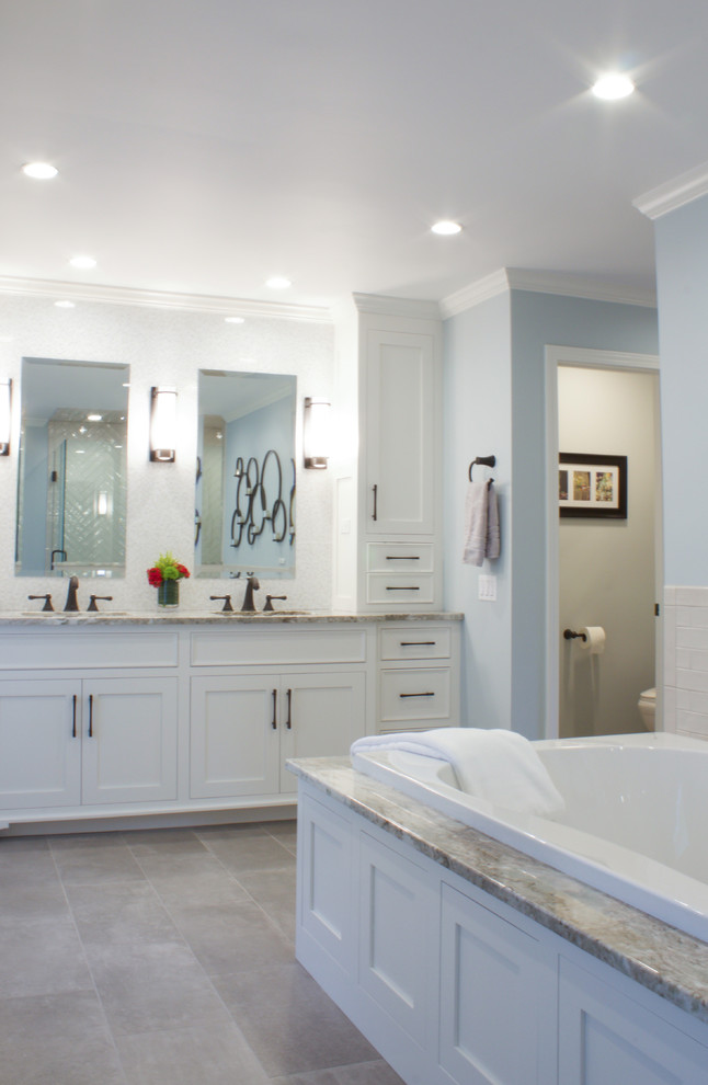 Large traditional ensuite bathroom in New York with flat-panel cabinets, white cabinets, a built-in bath, a built-in shower, a one-piece toilet, beige tiles, ceramic tiles, grey walls, porcelain flooring, a submerged sink, quartz worktops, grey floors, a hinged door and multi-coloured worktops.