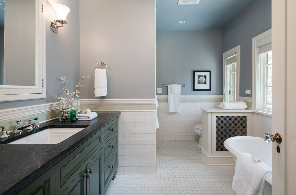 На фото: большая главная ванная комната в классическом стиле с отдельно стоящей ванной, плиткой кабанчик, врезной раковиной, фасадами с утопленной филенкой, зелеными фасадами, унитазом-моноблоком, белой плиткой, синими стенами, столешницей из искусственного кварца и белым полом с