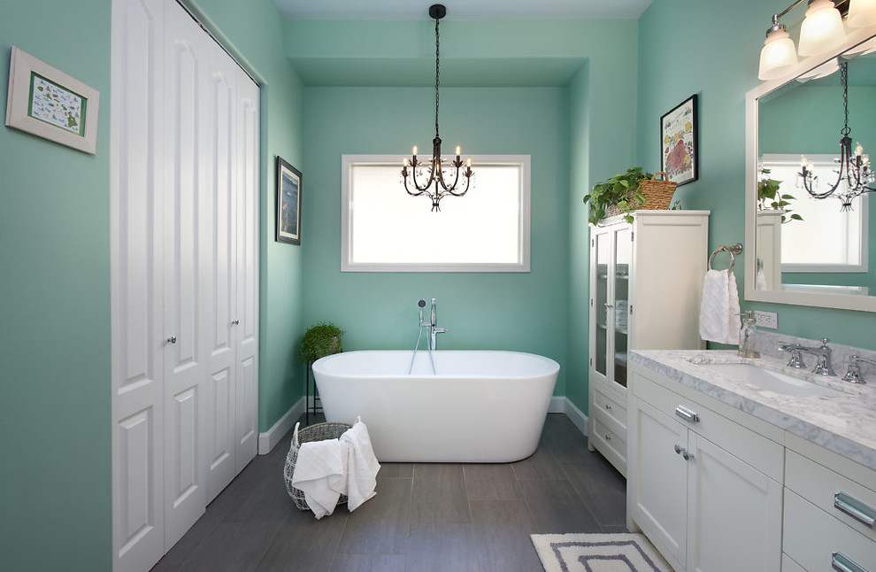 Inspiration for a large coastal master vinyl floor and gray floor bathroom remodel in Seattle with recessed-panel cabinets, white cabinets, green walls, an undermount sink, marble countertops and gray countertops