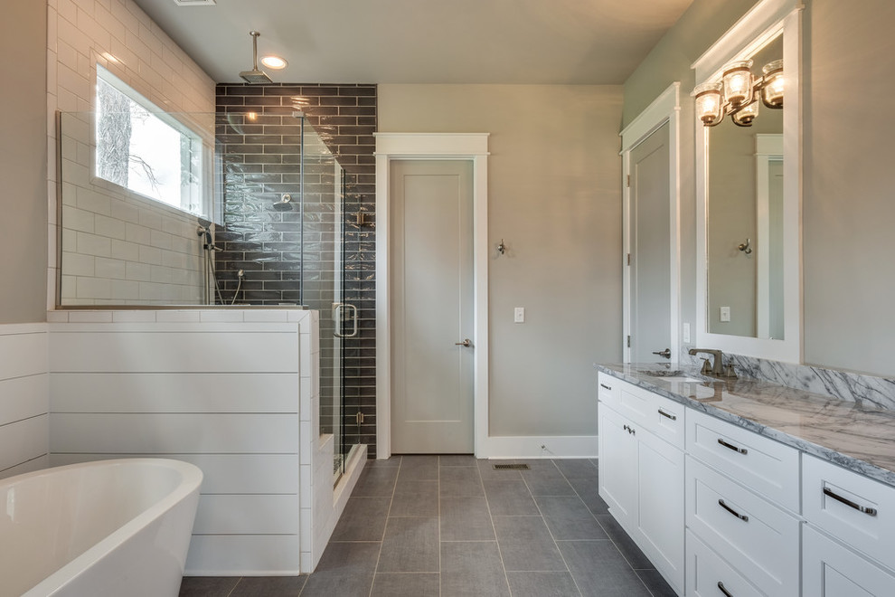 Foto de cuarto de baño principal, clásico renovado, grande, con armarios estilo shaker, puertas de armario blancas, bañera exenta, ducha esquinera, baldosas y/o azulejos blancos, baldosas y/o azulejos de cemento, paredes grises, suelo de pizarra, lavabo bajoencimera y ducha con puerta con bisagras
