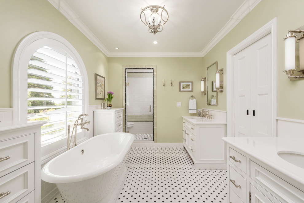 Medium sized mediterranean ensuite bathroom in San Francisco with recessed-panel cabinets, white cabinets, a freestanding bath, an alcove shower, a one-piece toilet, metro tiles, green walls, mosaic tile flooring, a submerged sink, engineered stone worktops, black floors, a hinged door and white worktops.