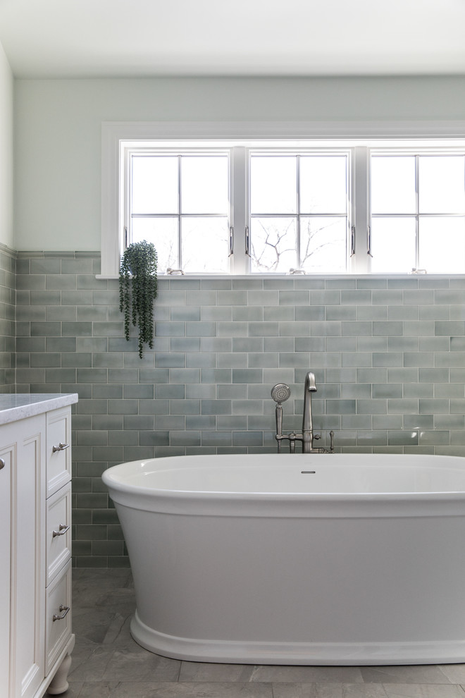 Design ideas for a traditional ensuite bathroom in Boston with recessed-panel cabinets, white cabinets, a freestanding bath, a built-in shower, a one-piece toilet, green tiles, ceramic tiles, marble flooring, a submerged sink, marble worktops, grey floors, an open shower and grey worktops.