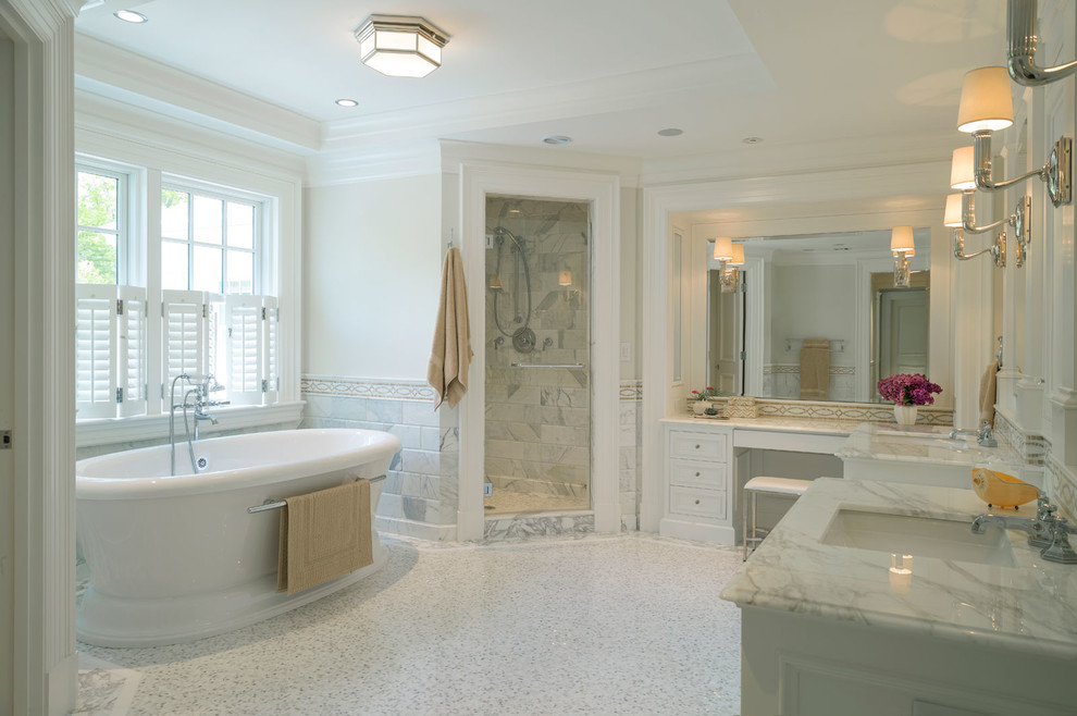 Aménagement d'une très grande salle de bain principale classique avec un placard avec porte à panneau encastré, des portes de placard blanches, une baignoire indépendante, une douche d'angle, un carrelage beige, un carrelage en pâte de verre, un mur blanc, un sol en carrelage de céramique, un lavabo posé et un plan de toilette en marbre.