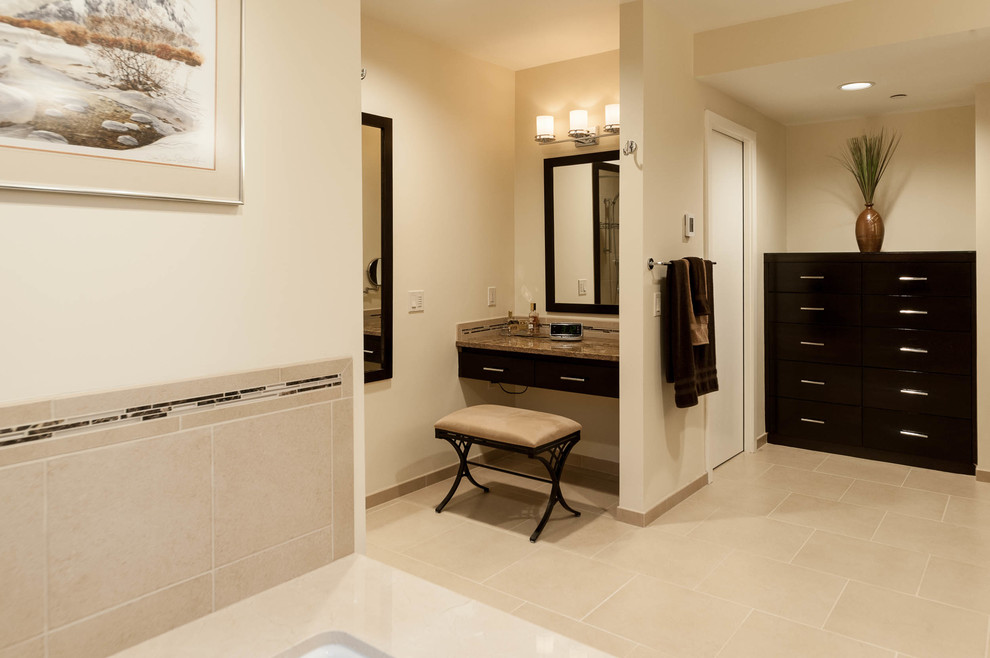 Large transitional master beige tile and porcelain tile porcelain tile alcove shower photo in Seattle with recessed-panel cabinets, dark wood cabinets, an undermount tub, a one-piece toilet, beige walls, an undermount sink and granite countertops