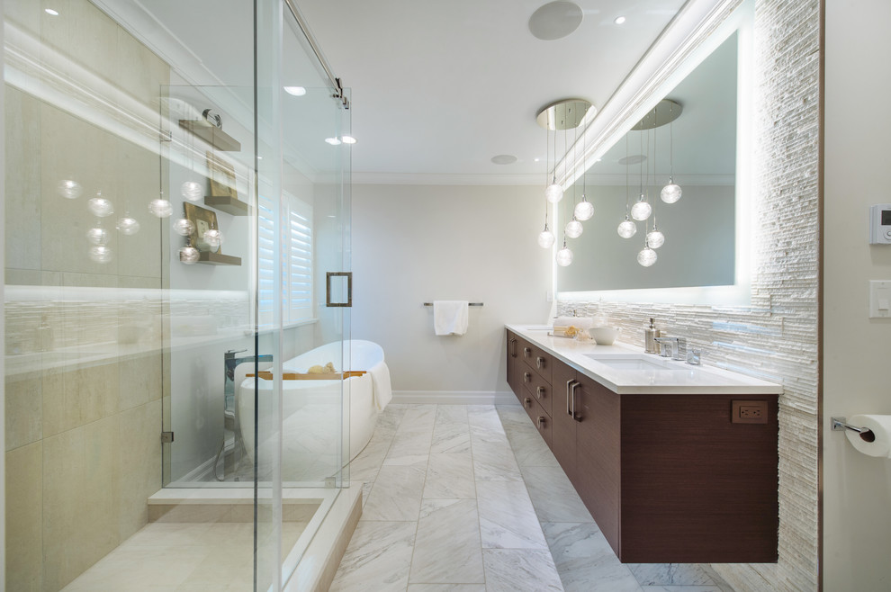 Bathroom - large transitional master stone tile and beige tile marble floor bathroom idea in Vancouver with an undermount sink, flat-panel cabinets, dark wood cabinets, quartz countertops, a one-piece toilet and gray walls