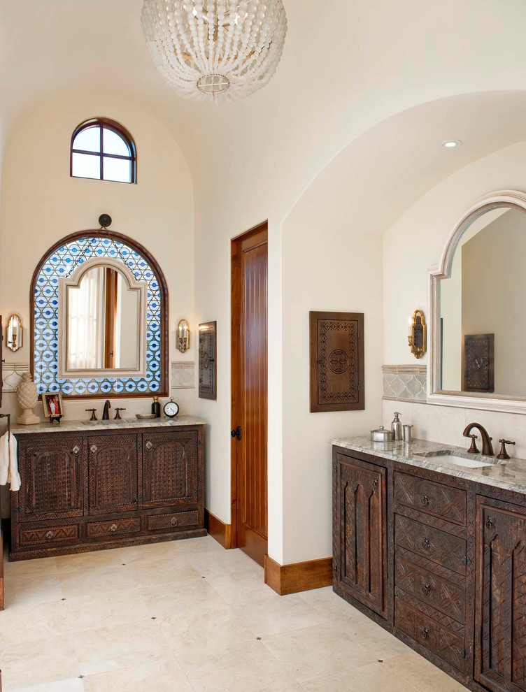 Tuscan travertine floor freestanding bathtub photo in San Diego with an undermount sink and quartzite countertops