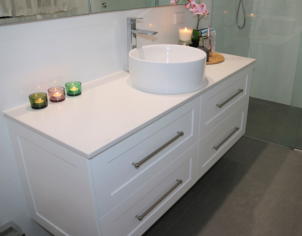 Inspiration for a large contemporary ensuite bathroom in Brisbane with shaker cabinets, white cabinets, a walk-in shower, white tiles, ceramic tiles, white walls, ceramic flooring, a built-in sink, engineered stone worktops and grey floors.