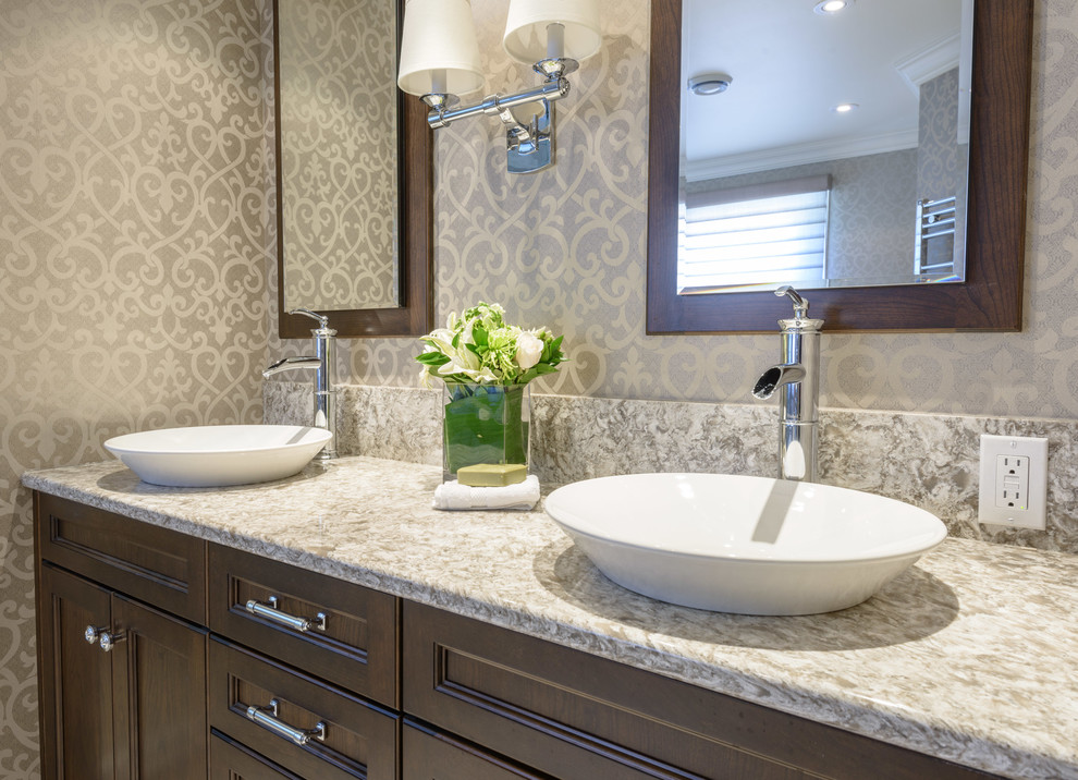 Mid-sized transitional master beige tile and porcelain tile ceramic tile and beige floor bathroom photo in Toronto with a vessel sink, quartzite countertops, recessed-panel cabinets, dark wood cabinets, gray walls and a hinged shower door