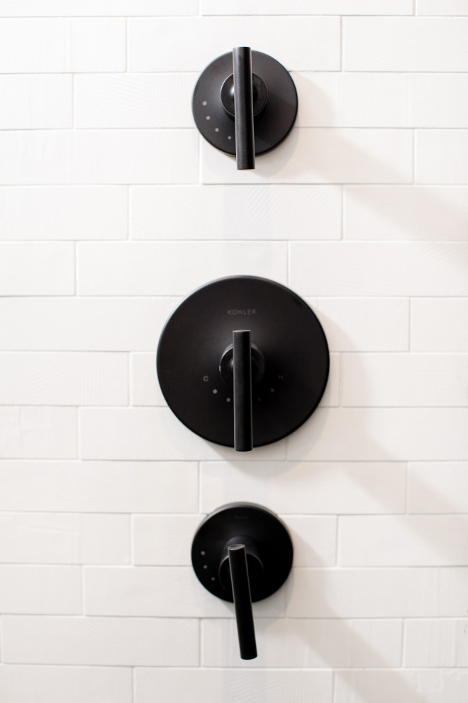 Inspiration for a medium sized traditional shower room bathroom in Austin with flat-panel cabinets, black cabinets, a one-piece toilet, black tiles, porcelain tiles, white walls, cement flooring, a built-in sink, engineered stone worktops, multi-coloured floors, a hinged door and white worktops.