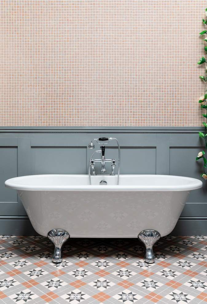 Photo of a large traditional bathroom in London with a freestanding bath, pink tiles, mosaic tiles, grey walls, porcelain flooring and multi-coloured floors.
