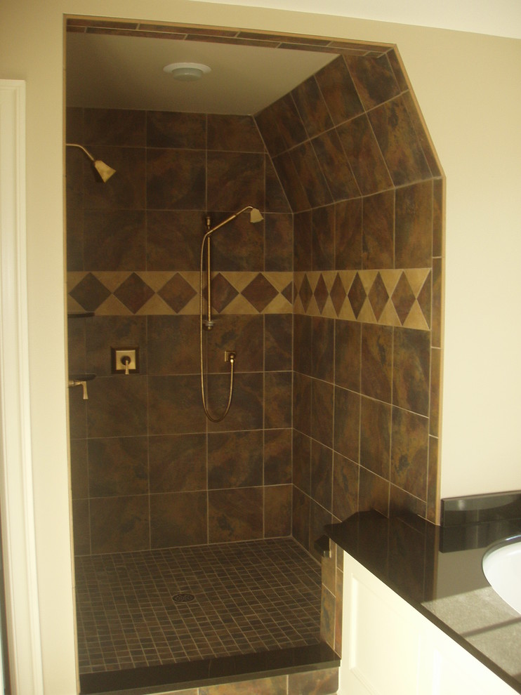This is an example of a medium sized classic ensuite bathroom in Baltimore with a submerged sink, flat-panel cabinets, white cabinets, granite worktops, a submerged bath, an alcove shower, a two-piece toilet, multi-coloured tiles, ceramic tiles, beige walls and ceramic flooring.