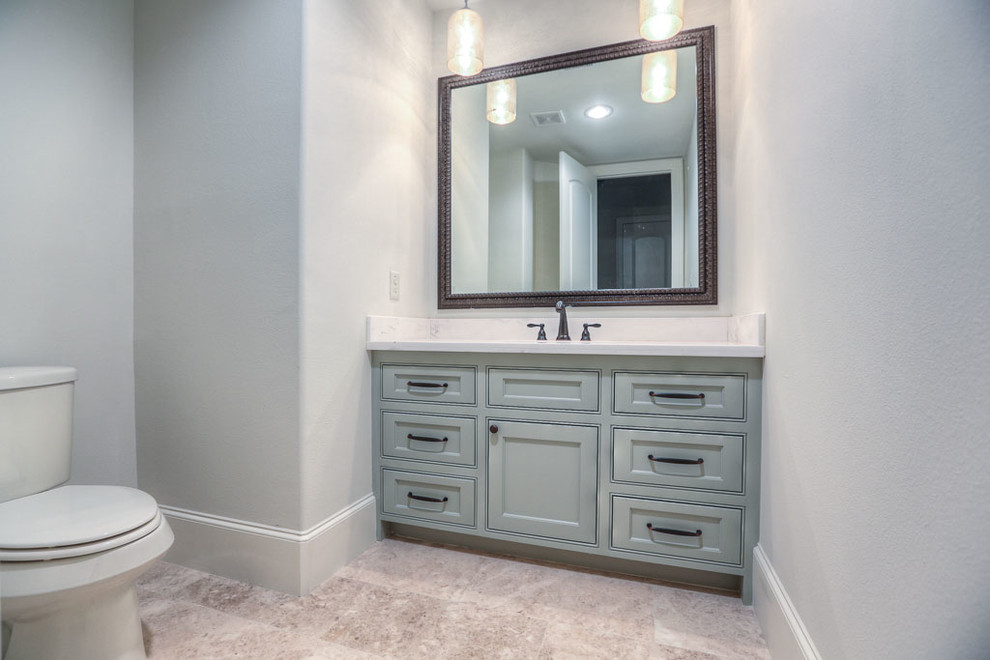 Example of a mid-sized classic 3/4 travertine floor bathroom design in Houston with an undermount sink, furniture-like cabinets, blue cabinets, granite countertops and gray walls