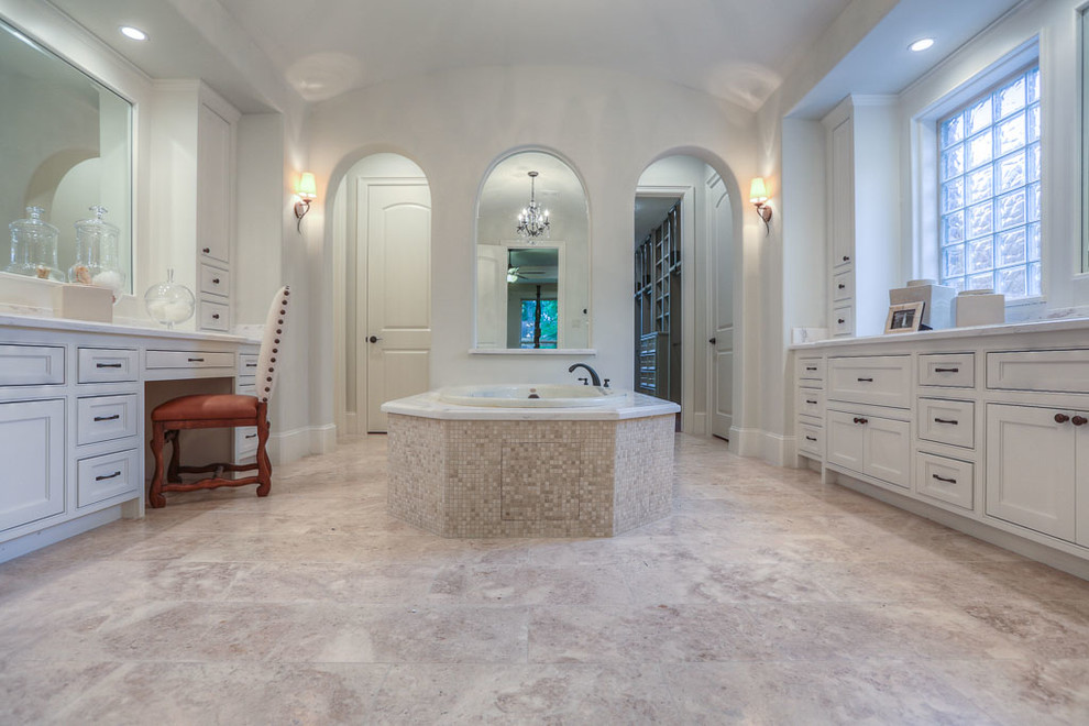 Double shower - mid-sized traditional master beige tile travertine floor double shower idea in Houston with an undermount sink, furniture-like cabinets, white cabinets, granite countertops, a hot tub, a one-piece toilet and gray walls