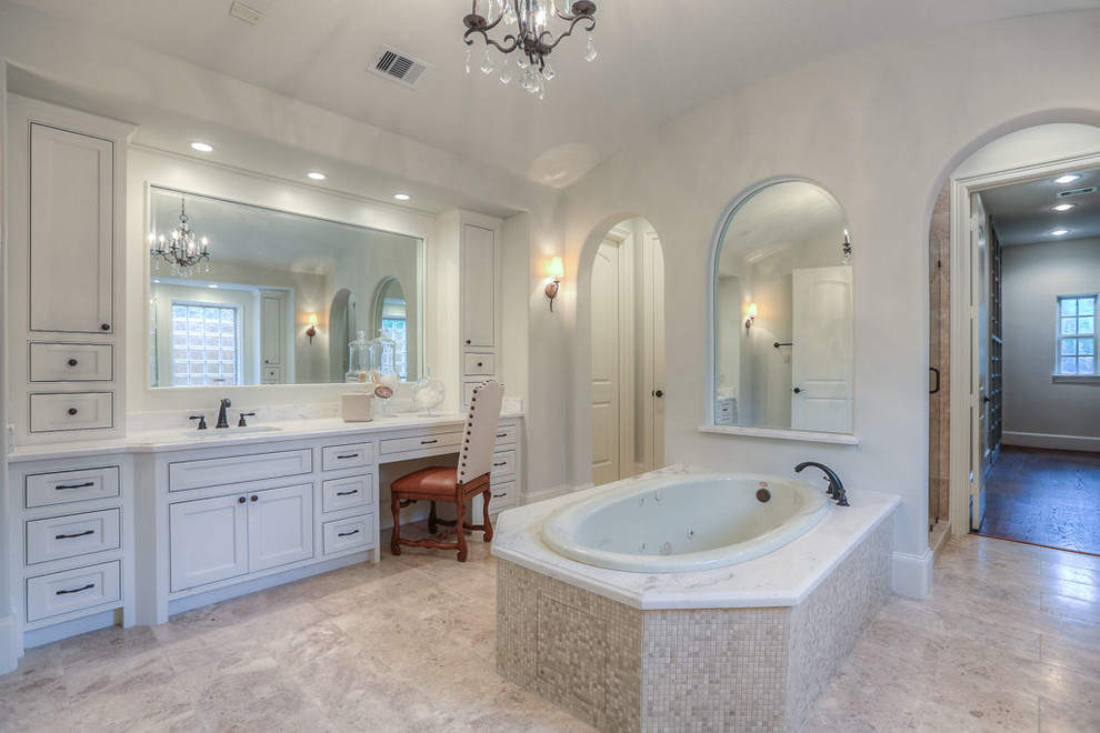 Mid-sized elegant master beige tile travertine floor double shower photo in Houston with an undermount sink, furniture-like cabinets, white cabinets, granite countertops, a hot tub, a one-piece toilet and gray walls