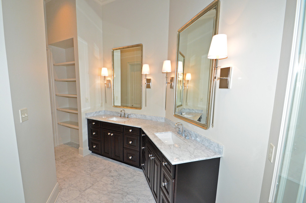 This is an example of a large traditional shower room bathroom in New Orleans with a submerged sink, raised-panel cabinets, dark wood cabinets, a corner shower, white tiles and white walls.