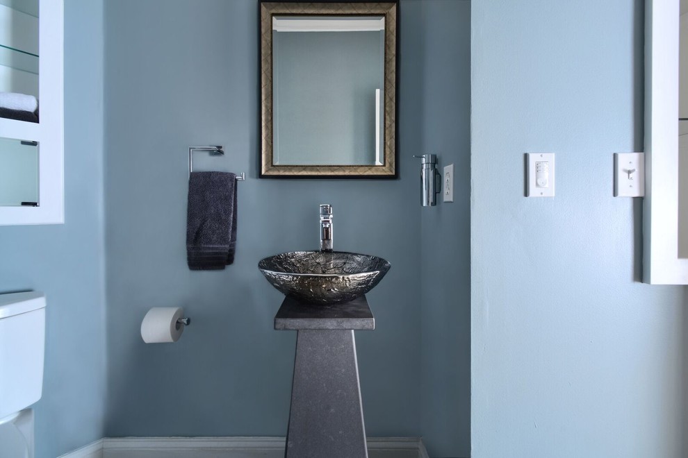 Cette photo montre une grande salle d'eau tendance en bois foncé avec un placard avec porte à panneau encastré, une baignoire posée, un espace douche bain, un mur bleu, une cabine de douche à porte battante, WC séparés, une vasque et un sol beige.