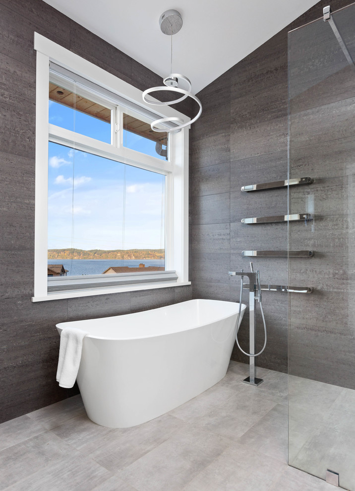 Inspiration for a large contemporary ensuite bathroom in Seattle with flat-panel cabinets, black cabinets, a freestanding bath, a built-in shower, grey tiles, porcelain tiles, grey walls, porcelain flooring, a submerged sink, engineered stone worktops, grey floors, an open shower and white worktops.