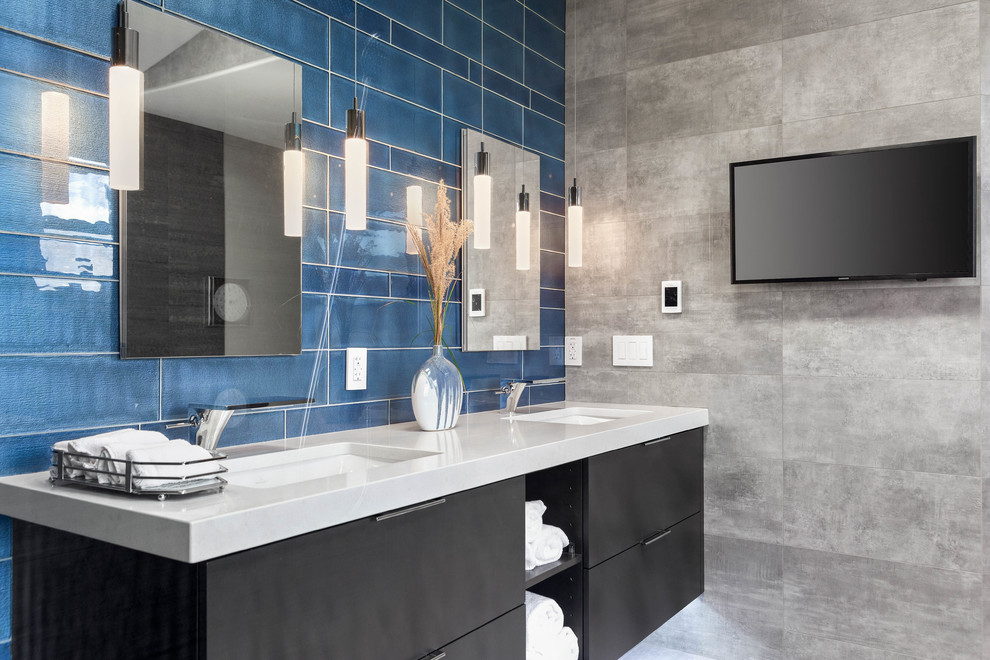 Large contemporary ensuite bathroom in Seattle with flat-panel cabinets, black cabinets, a freestanding bath, a built-in shower, grey tiles, porcelain tiles, grey walls, porcelain flooring, a submerged sink, engineered stone worktops, grey floors, an open shower and white worktops.