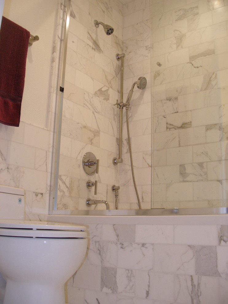 Medium sized traditional ensuite bathroom in San Francisco with flat-panel cabinets, dark wood cabinets, an alcove bath, a shower/bath combination, a one-piece toilet, black and white tiles, grey tiles, multi-coloured tiles, white tiles, stone tiles, beige walls, medium hardwood flooring, a submerged sink and marble worktops.