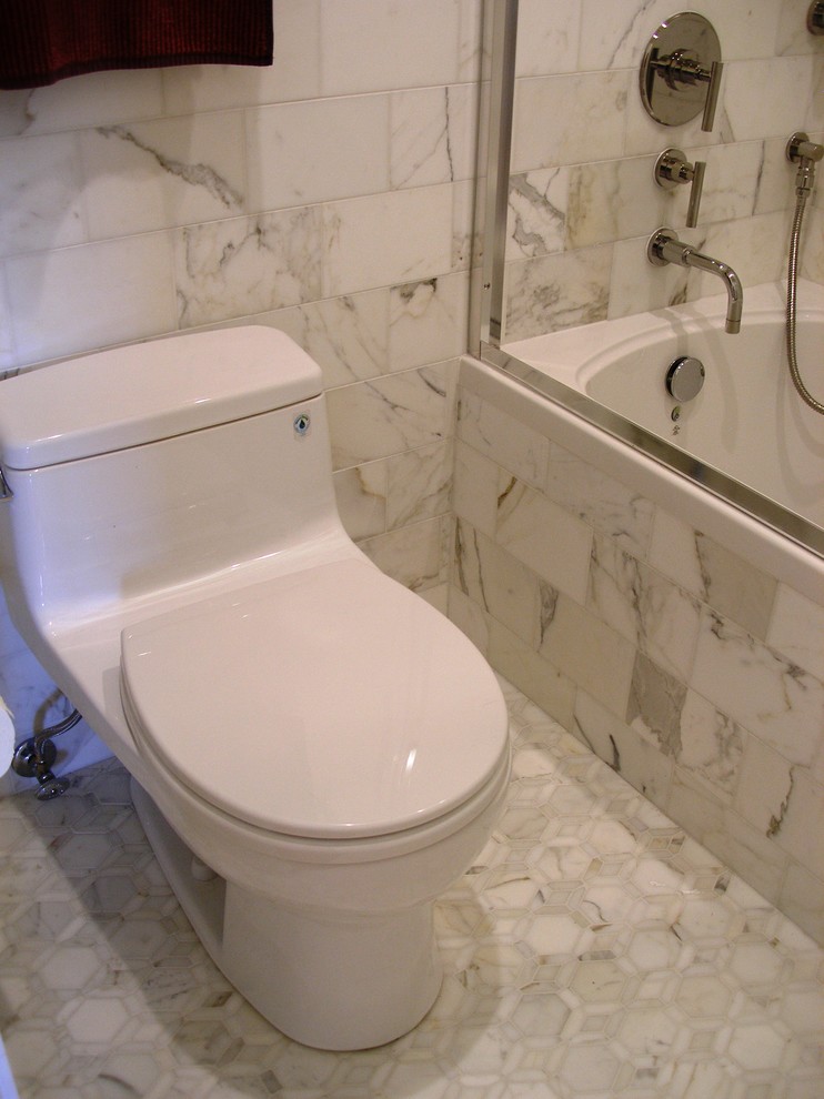 Inspiration for a medium sized classic ensuite bathroom in San Francisco with flat-panel cabinets, dark wood cabinets, an alcove bath, a shower/bath combination, a one-piece toilet, black and white tiles, grey tiles, multi-coloured tiles, white tiles, stone tiles, beige walls, medium hardwood flooring, a submerged sink and marble worktops.