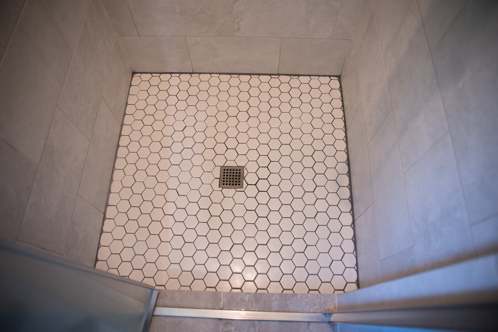 This is an example of a medium sized traditional shower room bathroom in Indianapolis with shaker cabinets, white cabinets, an alcove shower, mosaic tiles, beige walls, travertine flooring, an integrated sink and solid surface worktops.